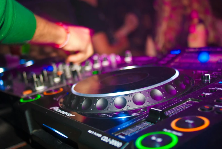 a close up of a dj playing music on a mixer, by Tom Bonson, pexels, in a nightclub, 🎨🖌️, college party, vivid details