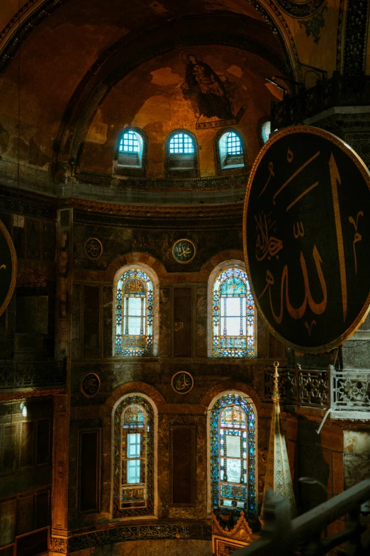 a picture of the inside of a building, a mosaic, trending on unsplash, art nouveau, black domes and spires, islamic calligraphy, byzantine, colorful signs