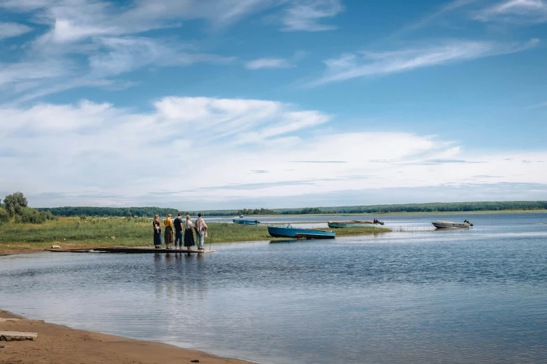 a group of people standing next to a body of water, by Peter Churcher, pexels contest winner, hurufiyya, thomas river, plain view, summer day, coming ashore