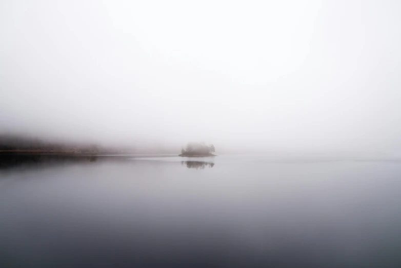 a boat floating on top of a lake on a foggy day, by Andrew Geddes, minimalism, hiding, an island, grey, landscape photograph