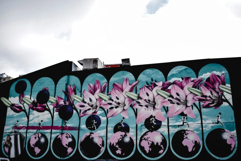 a mural painted on the side of a building, by Tom Bonson, pexels contest winner, psychedelic floral planets, blue black pink, lillies, city rooftop