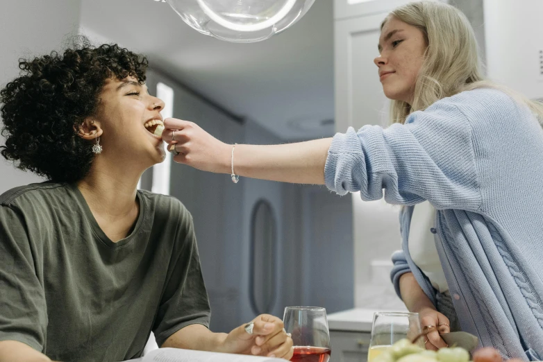 a woman feeding a boy a piece of food, trending on pexels, fantastic realism, non binary model, best friends, charli bowater and artgeem, profile image