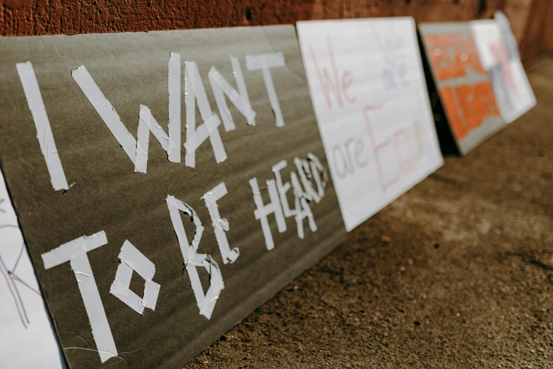 a group of signs that say i want to be happy, by Carey Morris, trending on unsplash, graffiti, protest, cardboard, 15081959 21121991 01012000 4k, waiting to strike