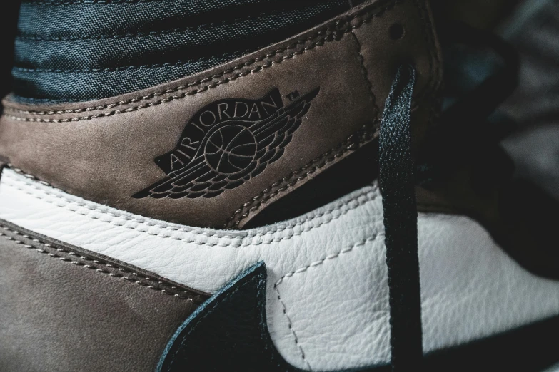 a close up of a pair of sneakers, a macro photograph, inspired by Jordan Grimmer, trending on unsplash, sots art, “air jordan 1, brown, high detailed close up of, jdm