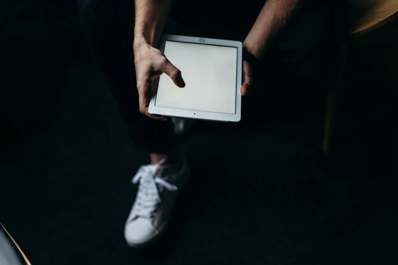 a person holding a tablet with a white screen, by Carey Morris, unsplash, sneaker photo, low key, 15081959 21121991 01012000 4k, instagram post