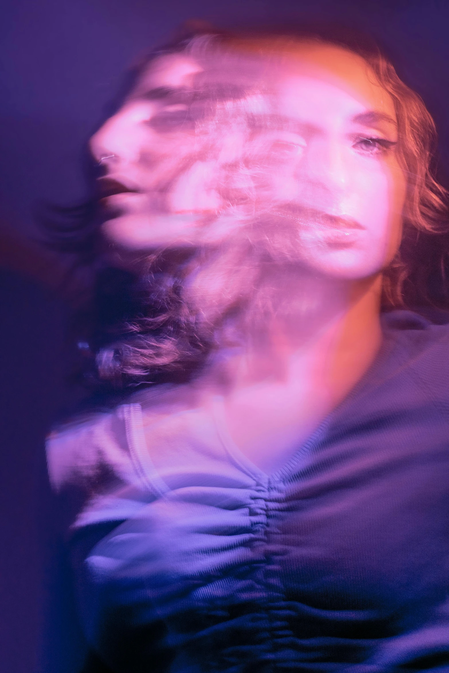 a woman with her hair blowing in the wind, an album cover, inspired by Nan Goldin, trending on pexels, holography, purple volumetric lighting, in the astral plane ) ) ), color image, translucent