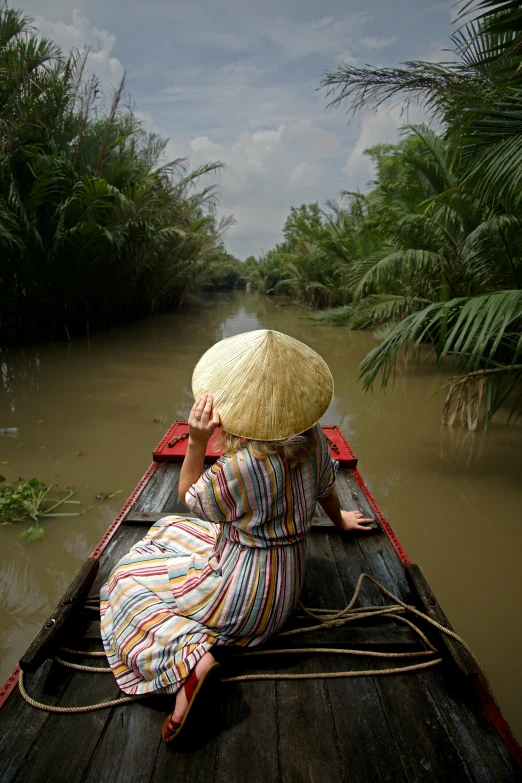 a woman sitting on top of a boat in a river, inspired by Steve McCurry, sumatraism, pith helmet, slide show, rectangle, tan