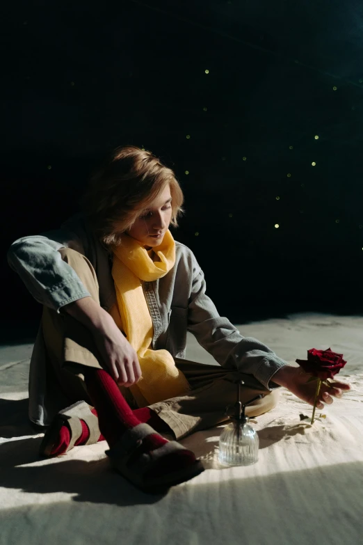 a woman sitting on the ground holding a teddy bear, an album cover, trending on pexels, magical realism, floating in the desert night, jodie whittaker, holding a red rose, in a space starry