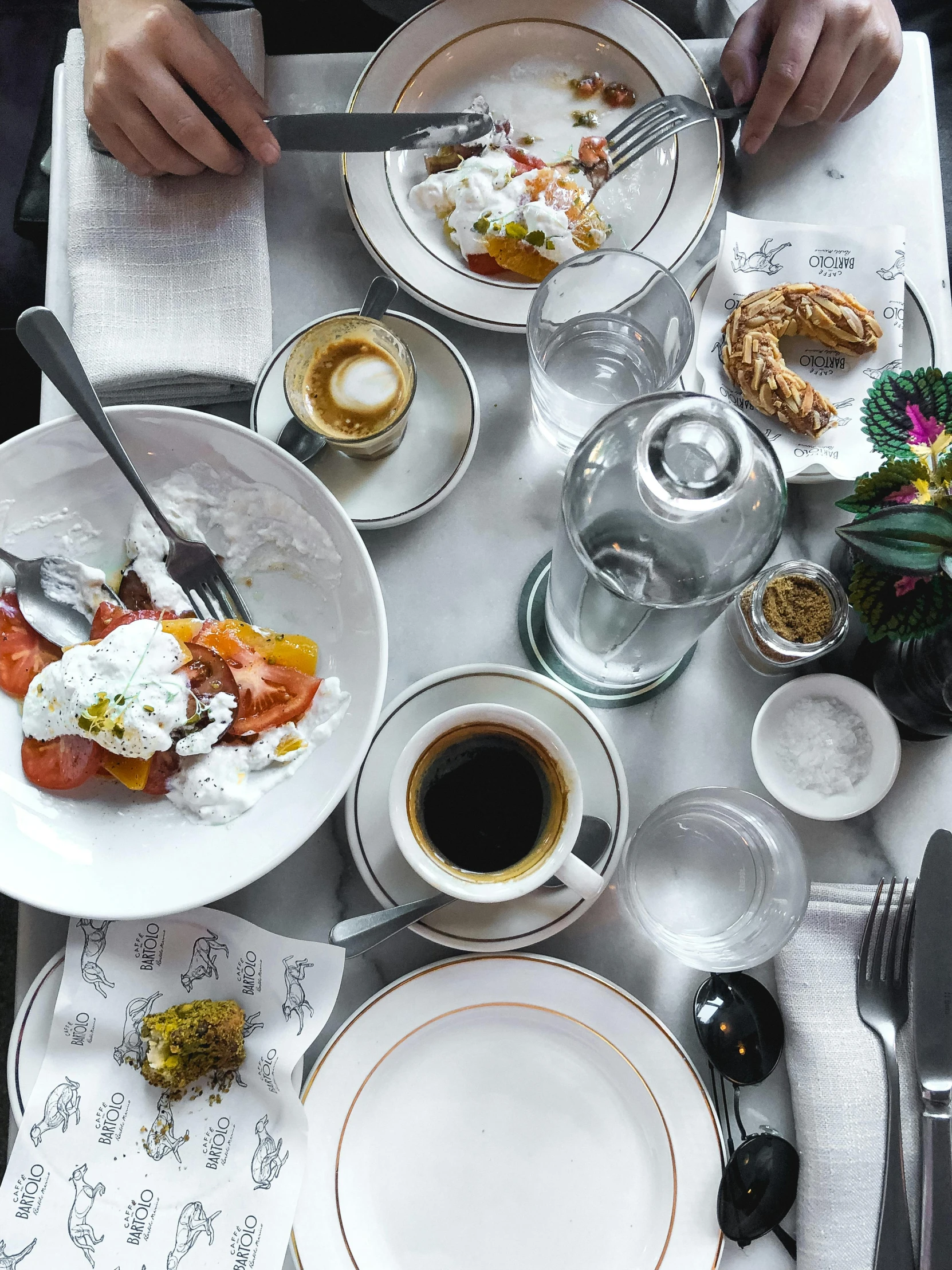 a person sitting at a table with plates of food, by Lucia Peka, trending on unsplash, hurufiyya, eggs benedict cumberbatch, [ overhead view of a table ]!!, white tablecloth, thumbnail