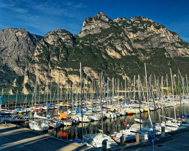 a harbor filled with lots of boats next to a mountain, by Giorgio De Vincenzi, pexels contest winner, al fresco, avatar image, high details photo