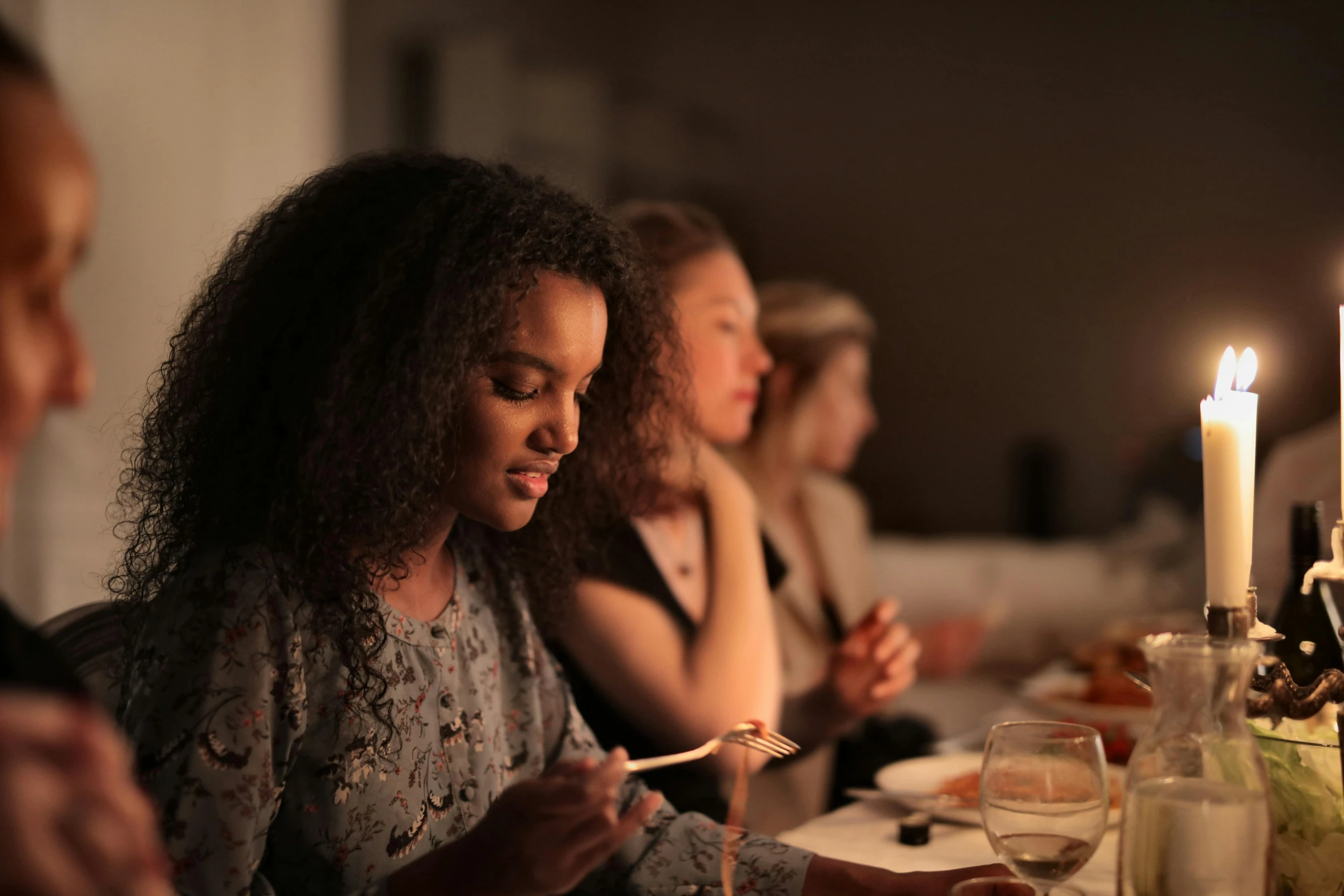 a group of people sitting around a dinner table, serene lighting, profile image, brown, diverse