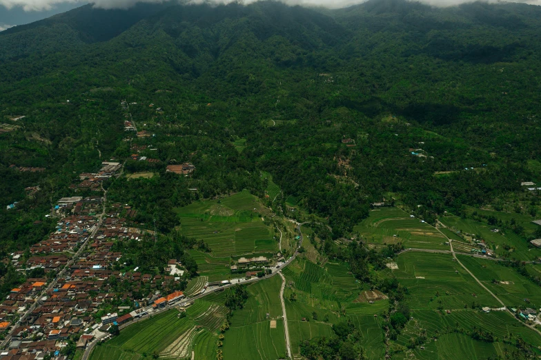an aerial view of a village in the mountains, sumatraism, background image, alessio albi, university, bali