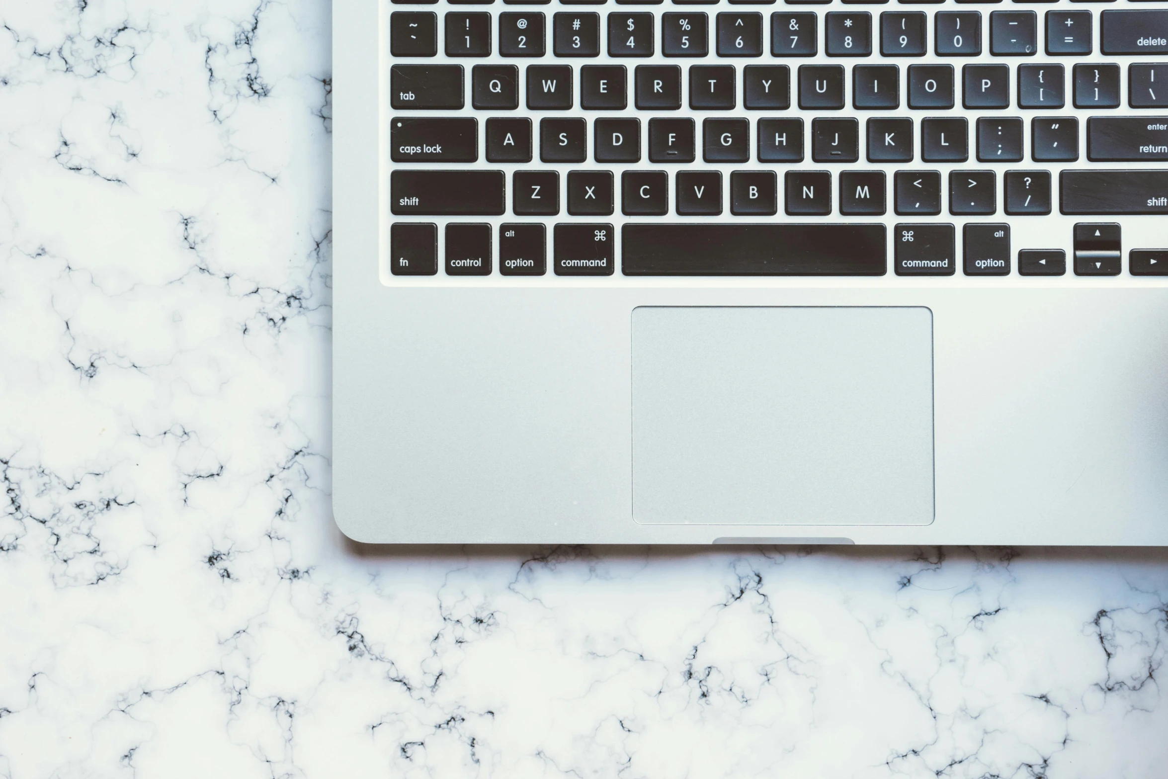 a laptop computer sitting on top of a marble table, trending on pexels, close-up from above, keyboards, background image, thumbnail