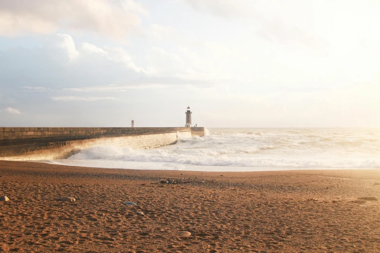 a man riding a surfboard on top of a sandy beach, by Yasushi Sugiyama, pexels contest winner, a road leading to the lighthouse, black sea, :: morning, near a jetty