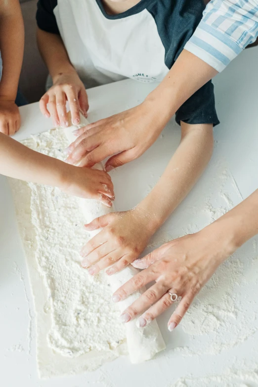 a group of people making dough on a table, by Arabella Rankin, trending on pexels, soft white rubber, ready to model, 5 fingers, ilustration