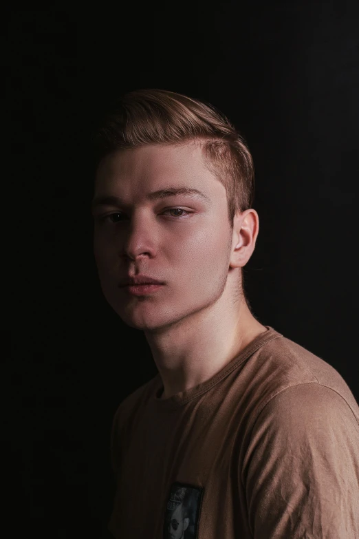 a young man standing in front of a black background, an album cover, inspired by Alexey Venetsianov, reddit, androgynous face, headshot profile picture, sunfaded, thicc