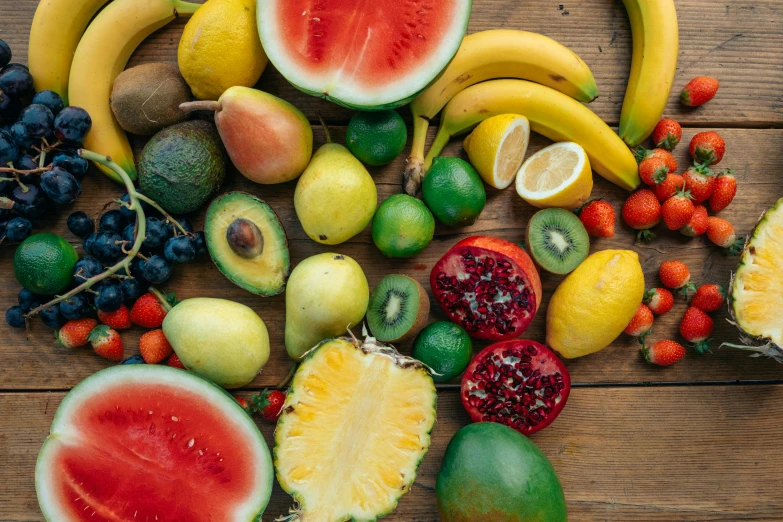 a bunch of fruit sitting on top of a wooden table, brightly coloured, background image