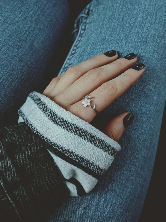 a person with a ring on their finger, 🍂 cute, wearing jeans and a black hoodie, high angle shot, “diamonds