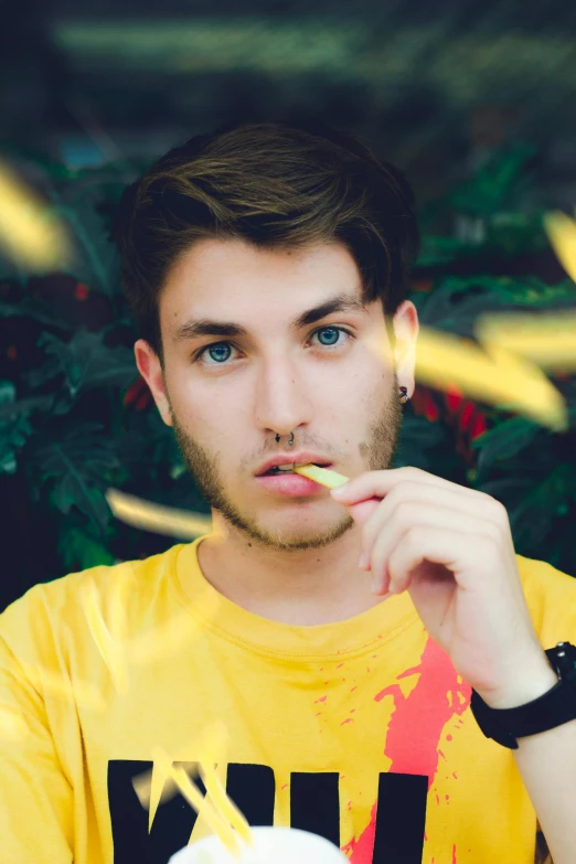 a man sitting at a table with food in front of him, inspired by John Luke, his eyes glowing yellow, headshot profile picture, model, ganja