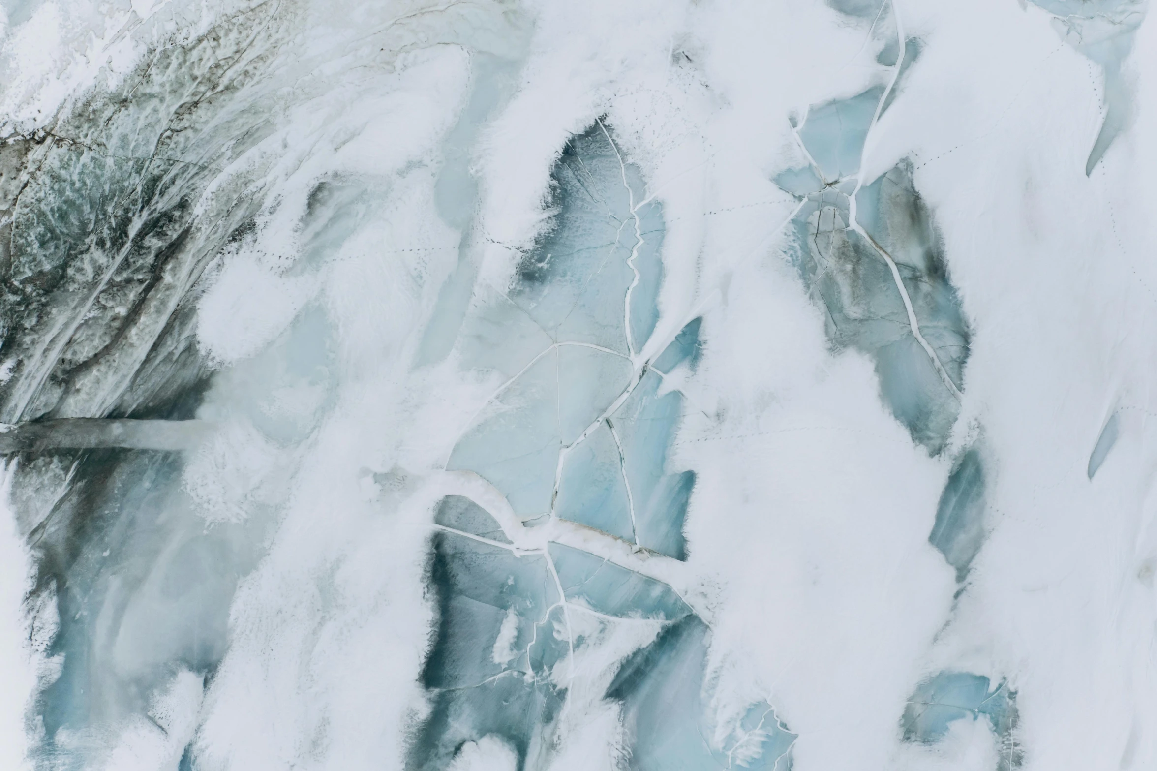 a man riding a snowboard down a snow covered slope, an album cover, trending on pexels, analytical art, marble texture, fjord, as seen from space, brushed white and blue paint