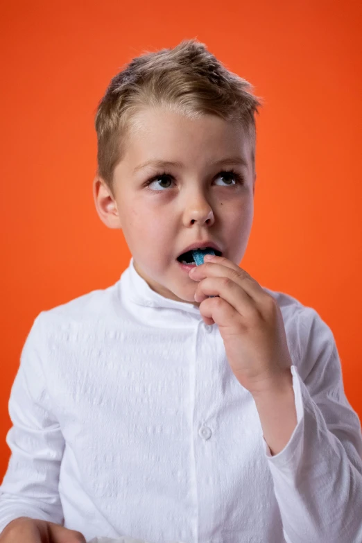 a young boy brushing his teeth with a toothbrush, an album cover, by James Warhola, shutterstock, in front of an orange background, 15081959 21121991 01012000 4k, formal portrait, snacks