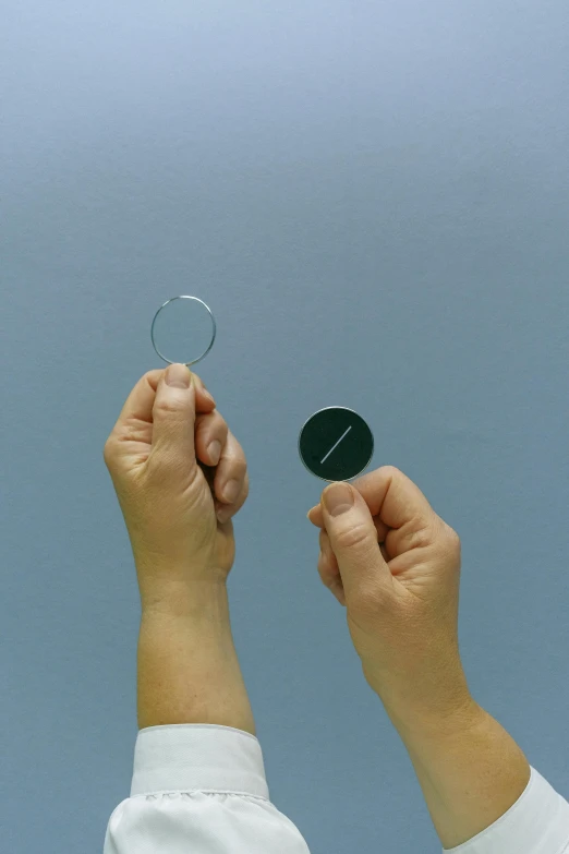 a person holding a mirror up in the air, inspired by László Moholy-Nagy, optical illusion, silver small small small glasses, hook as ring, ultra accurate, silicon and carbon