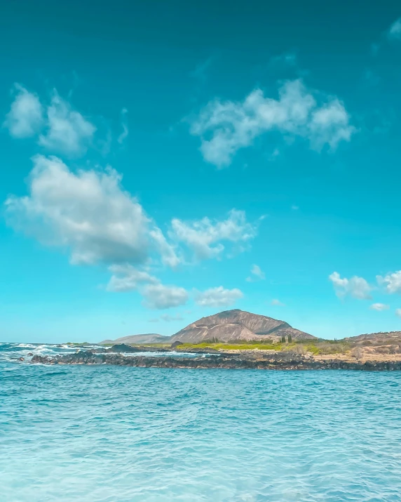 a body of water with a small island in the background, wild ocean background, listing image, fan favorite, skies