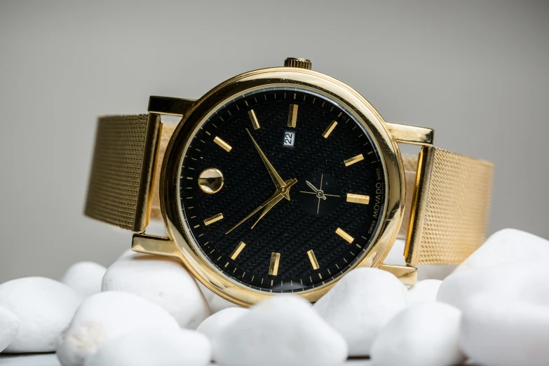 a gold watch sitting on top of a pile of snow, by Matt Cavotta, pexels contest winner, renaissance, black marble and gold, modern minimalist f 2 0, gemstones and gold, a handsome