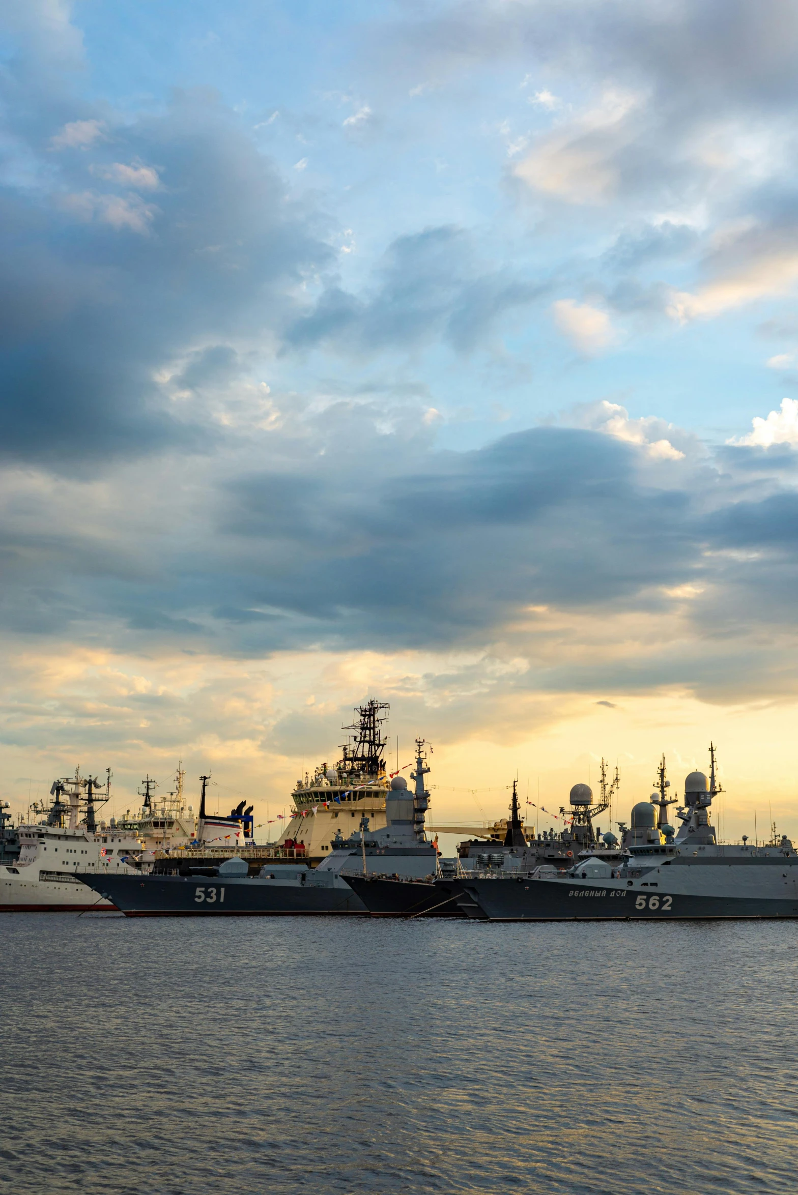 a group of ships sitting on top of a body of water, a picture, by Sven Erixson, unsplash, photo of putin, summer evening, navy, square