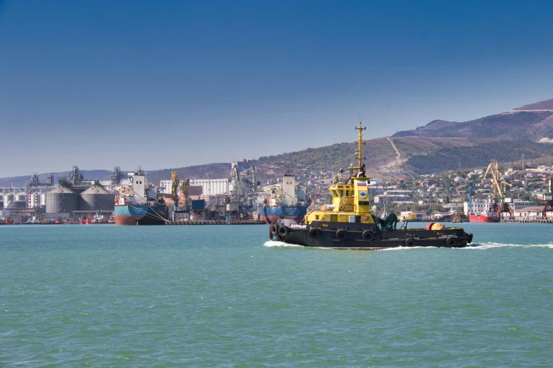 a tug boat in the middle of a body of water, a picture, shutterstock, rostov city, south african coast, high quality product image”