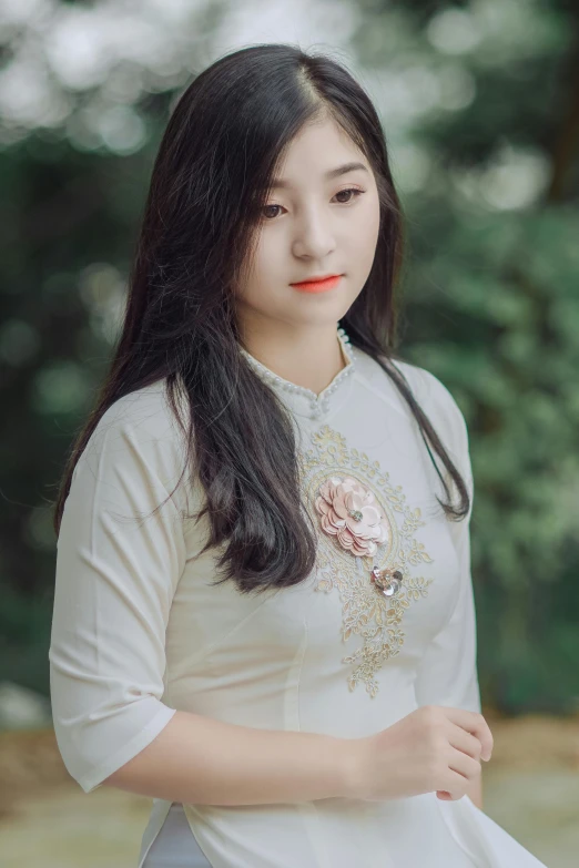 a woman in a white dress posing for a picture, a picture, inspired by Jin Nong, pexels contest winner, realism, embroidered shirt, square, low quality photo, beautiful young asian woman