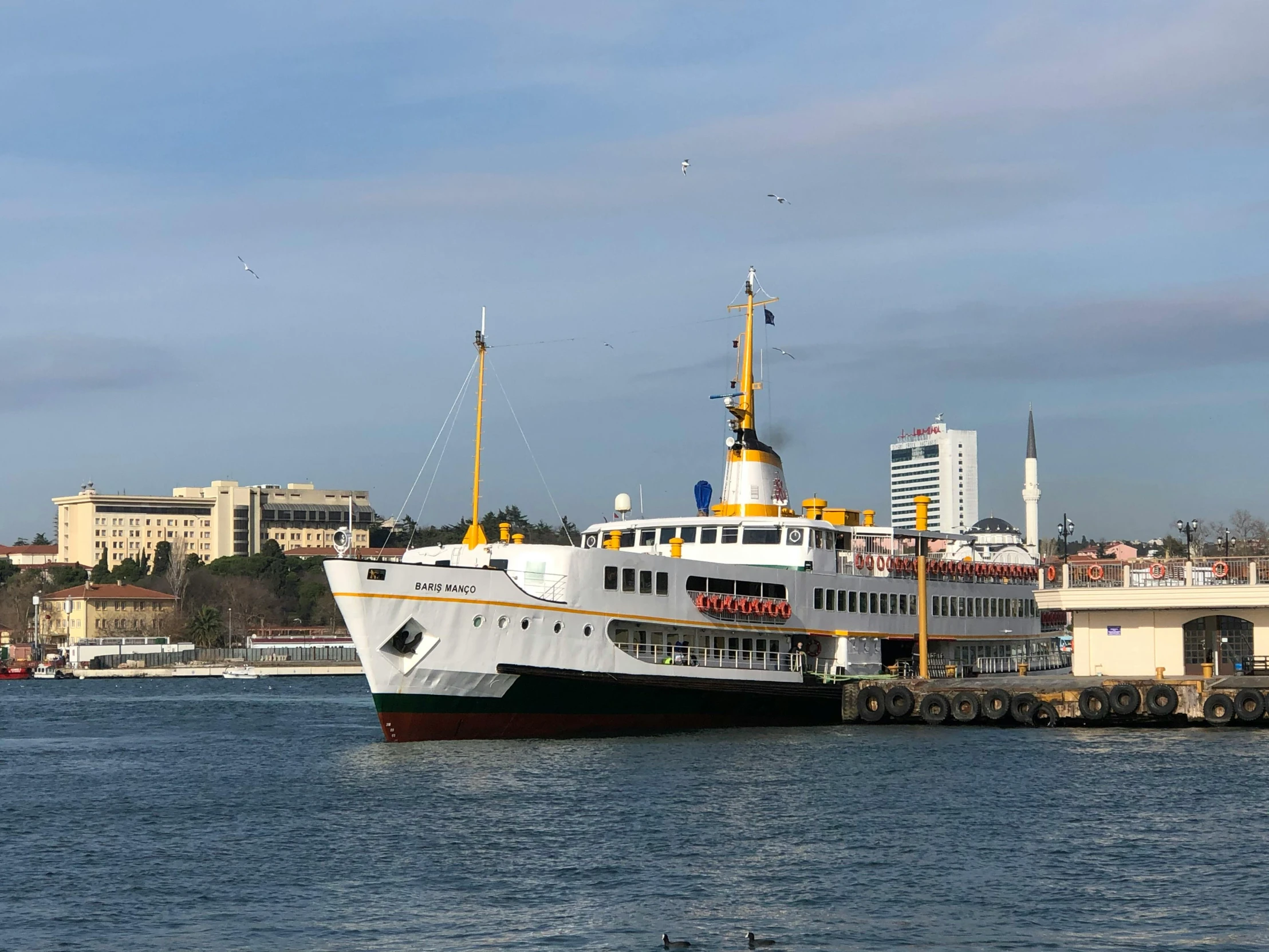 a large white boat sitting on top of a body of water, hurufiyya, istanbul, white and yellow scheme, trams, eve venture