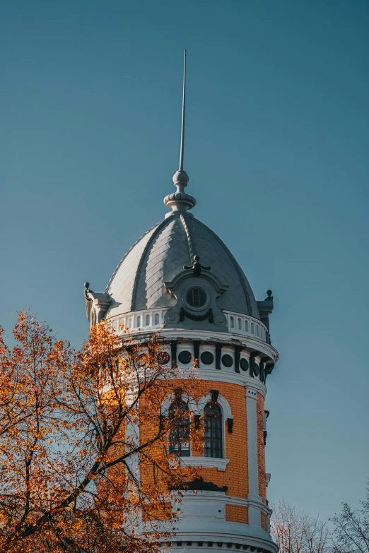 a tall tower with a clock on top of it, by Sven Erixson, unsplash contest winner, art nouveau, autum, capital of estonia, rounded roof, high quality photo