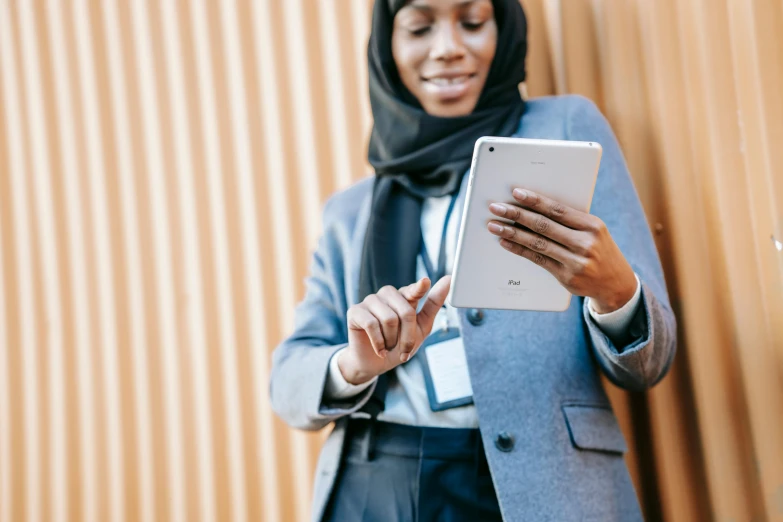 a woman in a hijab using a tablet, by Carey Morris, trending on unsplash, corporate phone app icon, woman in business suit, somali woman, thumbnail