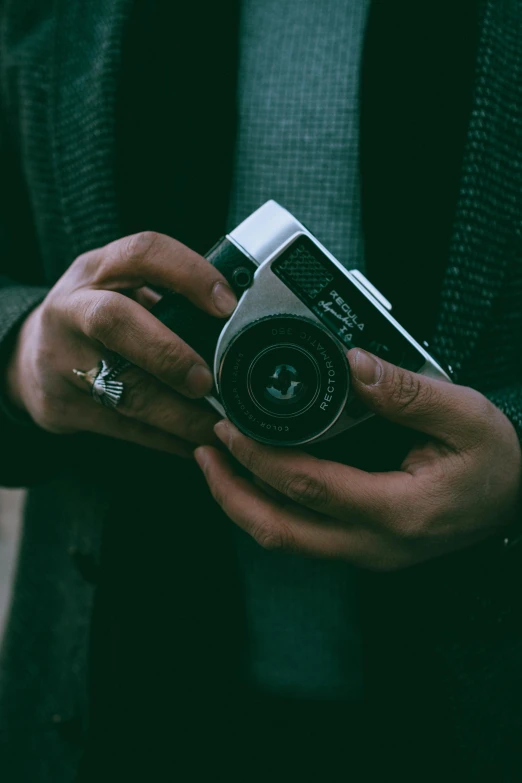 a person holding a camera in their hands, pexels contest winner, retro dark vintage, hasselblad quality, low colour, gentleman