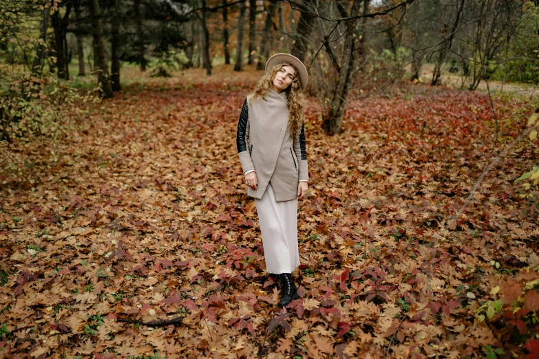 a woman standing in a field of leaves, by Emma Andijewska, pexels, multilayered outfit, beige, 15081959 21121991 01012000 4k, thumbnail