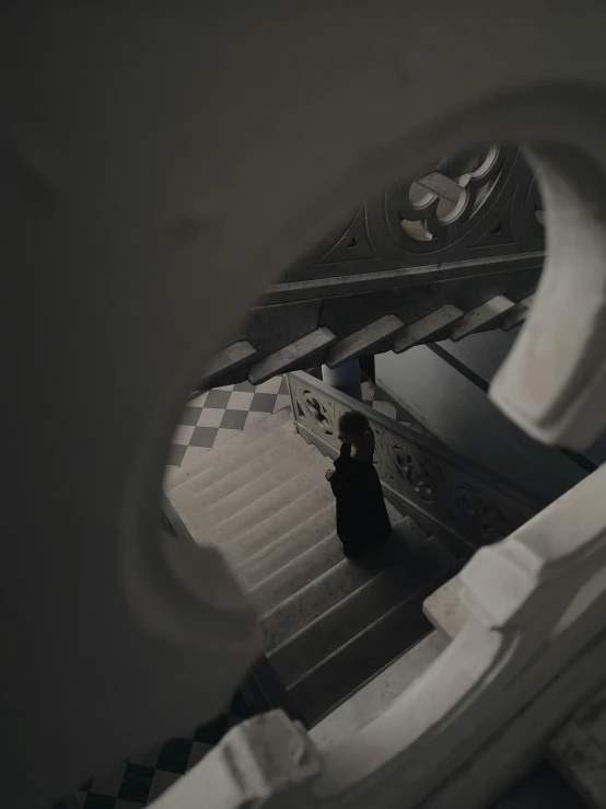 a person walking down a set of stairs, inspired by Mihály Munkácsy, unsplash contest winner, renaissance, dressed in a black cloak, inside a marble, ( ( theatrical ) ), gif