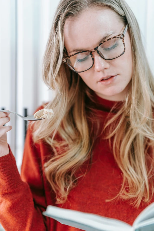 a woman in a red sweater is reading a book, inspired by Louisa Matthíasdóttir, trending on pexels, eating spaghetti from a bowl, wearing gold glasses, sydney sweeney, profile image