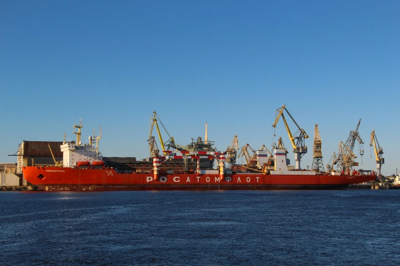 a large red boat sitting on top of a body of water, a portrait, shipping docks, russia in 2 0 2 1, dlsr photograph, borealis