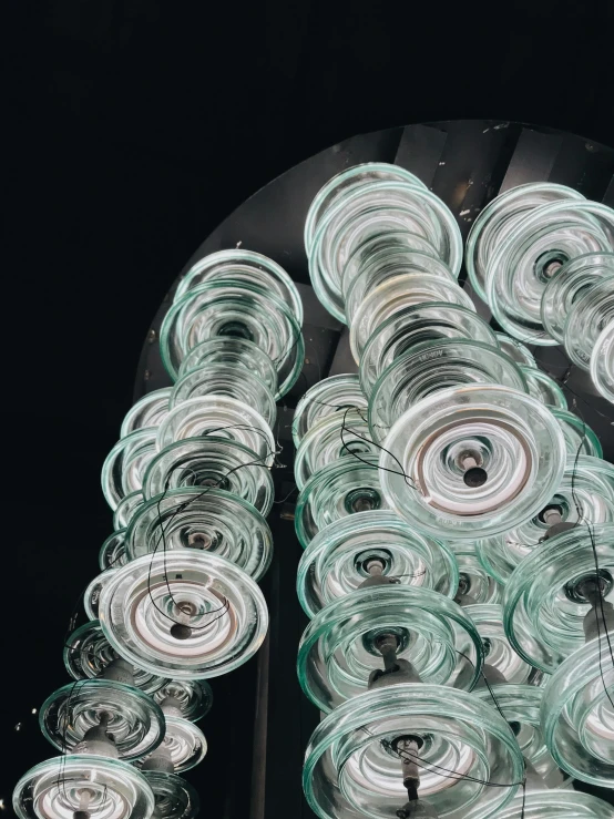 a bunch of wine glasses sitting on top of a table, inspired by Bruce Munro, unsplash contest winner, kinetic art, 3/4 view from below, texture detail, spiraling, mint higlights