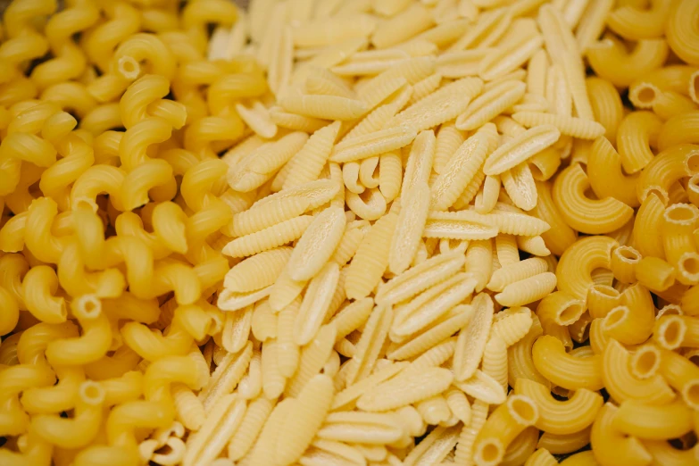 a pile of pasta sitting on top of a table, half image, yellow, thumbnail, digital image