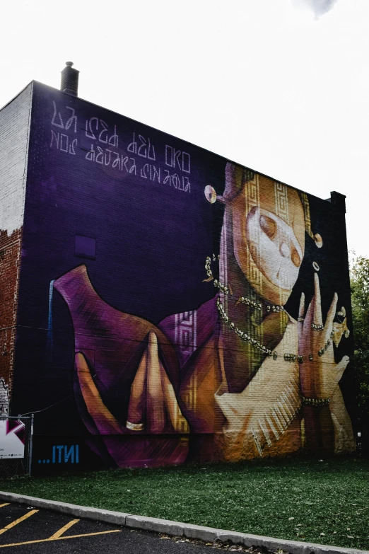 a large mural on the side of a building, graffiti art, by Naza, pexels contest winner, draped in silky purple and gold, sectoid, her back is to us, instagram picture