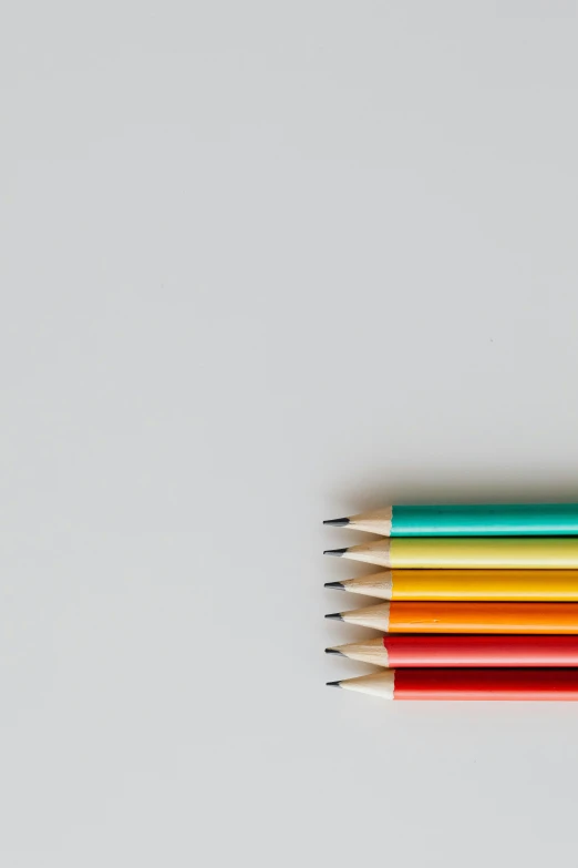 a group of colored pencils sitting on top of each other, a minimalist painting, by Matthias Stom, trending on pexels, postminimalism, !pencil, graphite, !!! colored photography, flat minimalistic