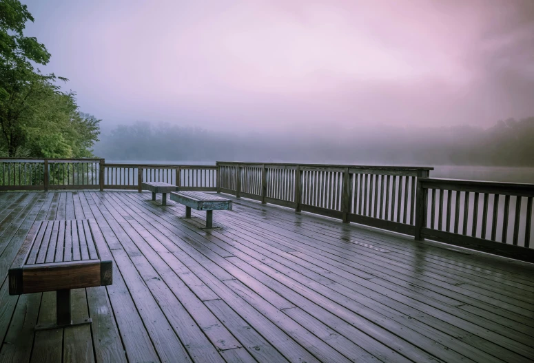 a couple of benches sitting on top of a wooden deck, by Jessie Algie, unsplash, purple fog, lake house, pink mist, grey