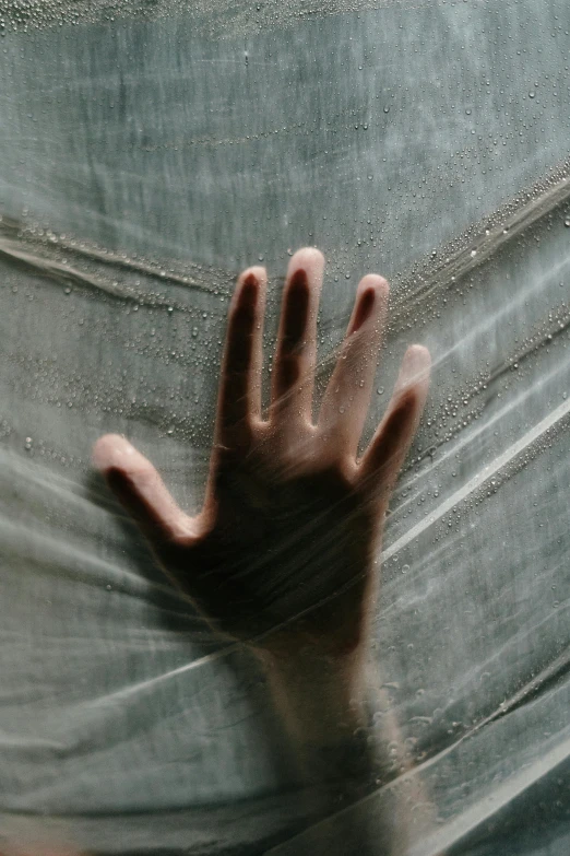 a close up of a person's hand behind a sheet, inspired by Elsa Bleda, pexels, conceptual art, translucent and slimy flesh, cobweb, ilustration, curtain