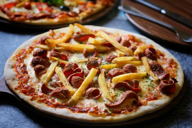 a couple of pizzas sitting on top of a table, by Joe Bowler, with fries, chorizo sausage, casual game, thumbnail