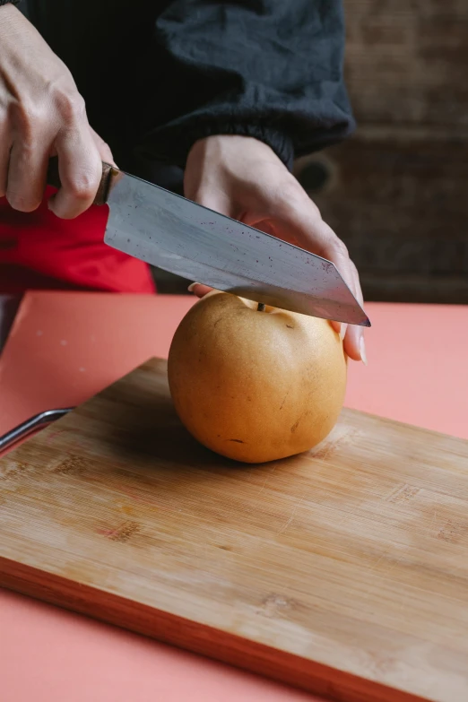 a person cutting an apple on a cutting board, inspired by Kanō Naizen, unsplash, renaissance, no - text no - logo, low detail, patagonian, peach