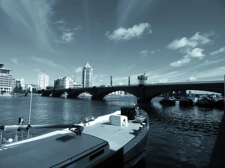 a boat sitting on top of a river next to a bridge, inspired by Thomas Struth, pexels contest winner, minimalism, glasgow in background, shades of blue and grey, high contrast 8k, medium format