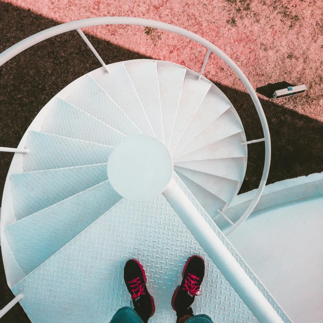 a person standing at the top of a spiral staircase, by Anna Haifisch, pexels contest winner, hypermodernism, pink shoes, sport, pink white turquoise, 5k