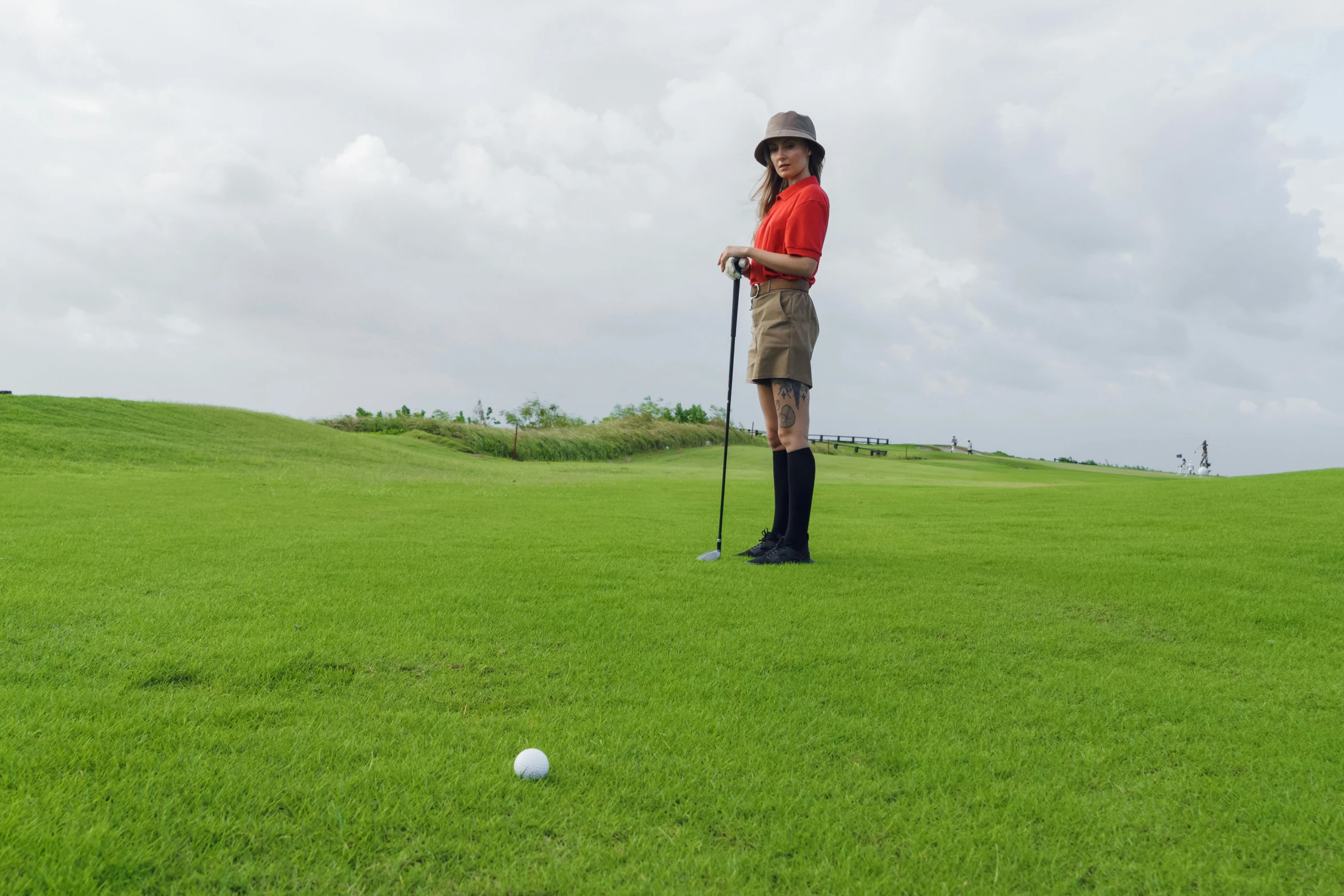 a man standing on top of a green field next to a golf ball, girl wearing uniform, puerto rico, avatar image, vacation photo